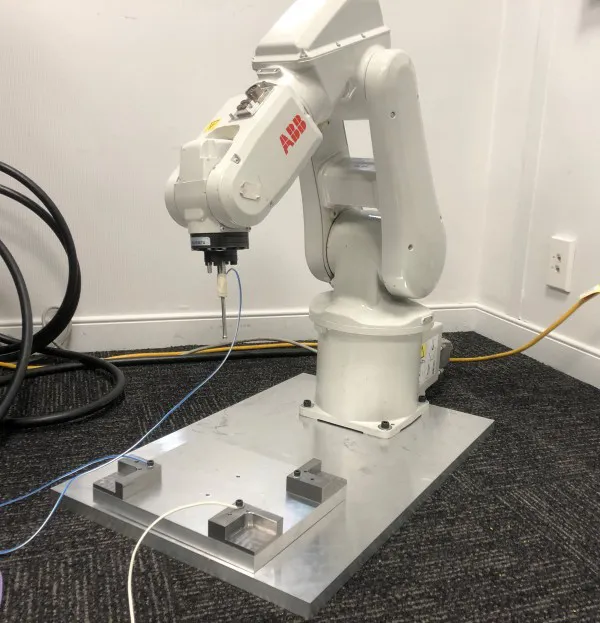 Robot and touch probe during the testing phase at Facteon's facility.